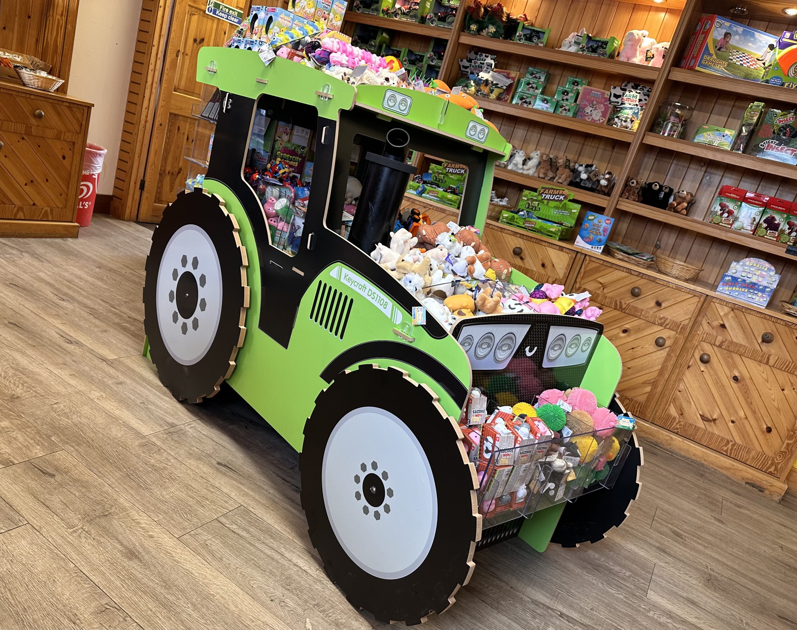 A green tractor with a toy inside